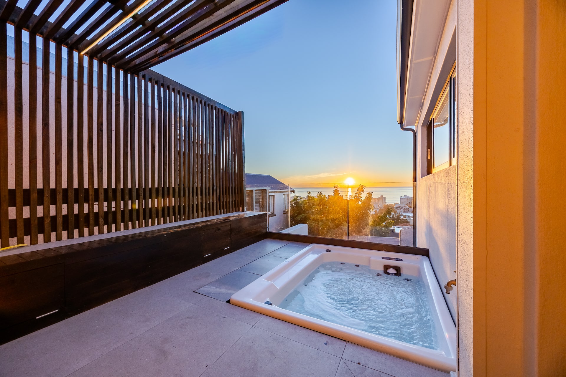 The private hot tub on the deck at The Firdale at sunset, Sea Point